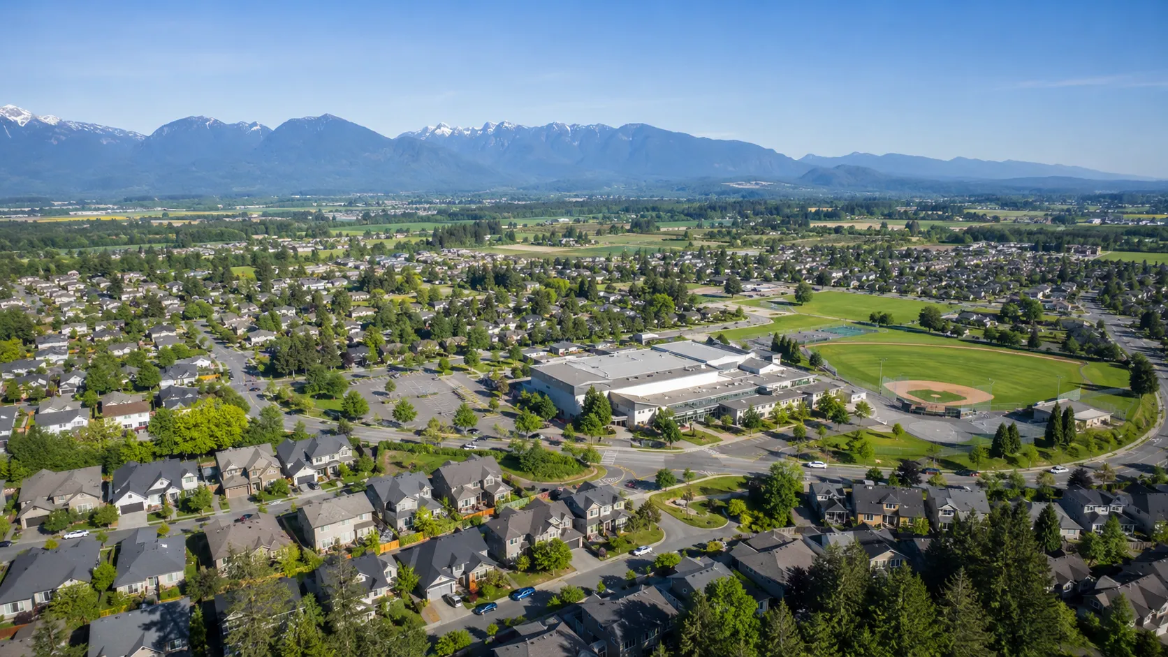 Family reviewing Abbotsford home listings by school catchment with a local realtor